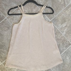 Cream colored tank with gold accent. Never worn.